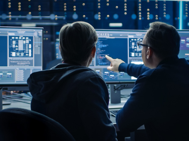 Cybersecurity specialists monitoring systems