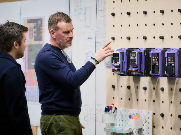 Engineers examining connected drive equipment